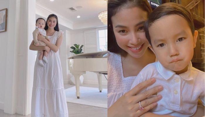 Phạm Hương lại mặc váy rộng thùng thình bế con, lộ cánh tay như mẹ bầu