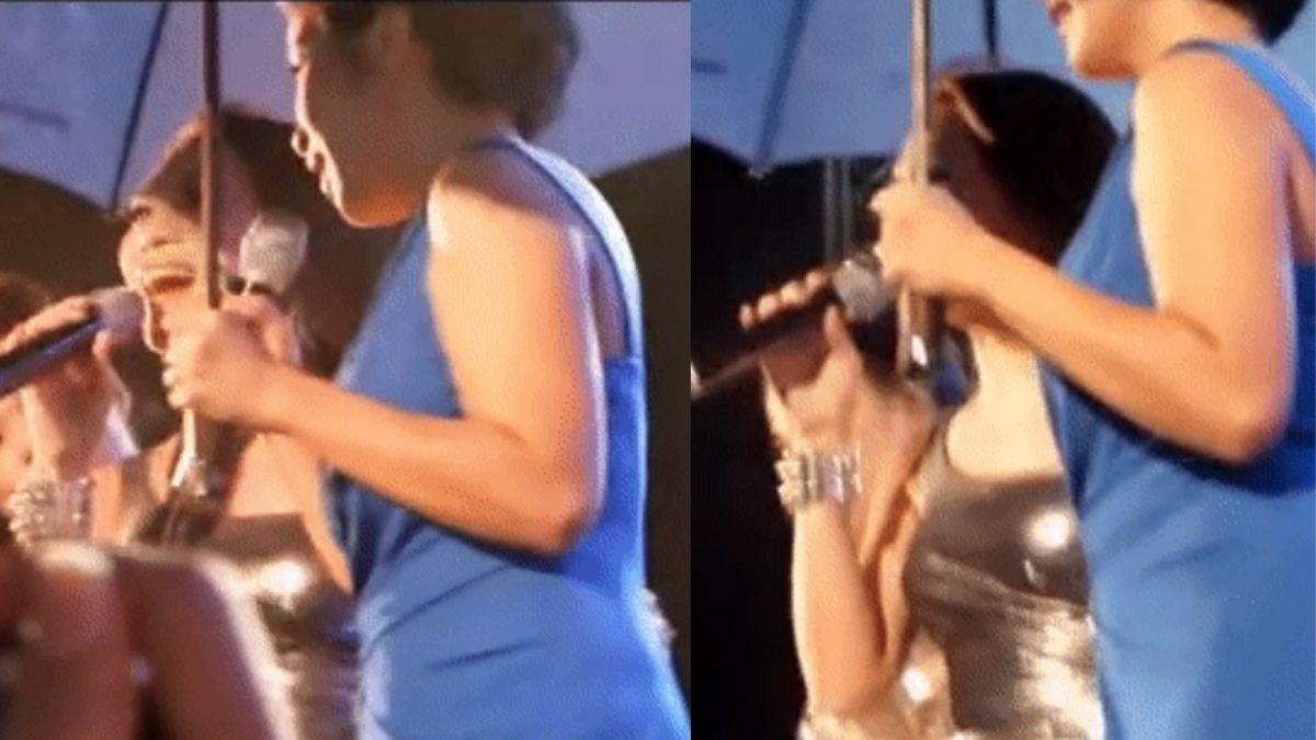 Diva Mỹ Linh hạ mình cầm ô che cho Mỹ Tâm biểu diễn trên sân khấu