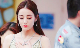 Địch Lệ Nhiệt Ba luôn lặp đi lặp lại hành động này khi diện áo trễ cổ