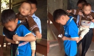 Hình ảnh hai anh lớn địu em út vượt đèo đến trường khiến bao người rơi lệ