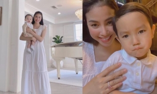 Phạm Hương lại mặc váy rộng thùng thình bế con, lộ cánh tay như mẹ bầu