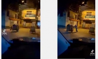 Bé trai 2 tuổi đạp xe theo mẹ lao công đi gom rác giữa đêm đông