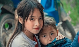 Bé gái Hà Giang bế em bên đường bão mạng với vẻ đẹp thuần khiết, xinh xắn