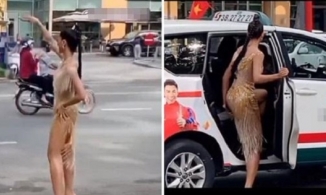 H'Hen Niê mặc Nguyên đầm dạ hội đứng vẫy taxi ngoài đường