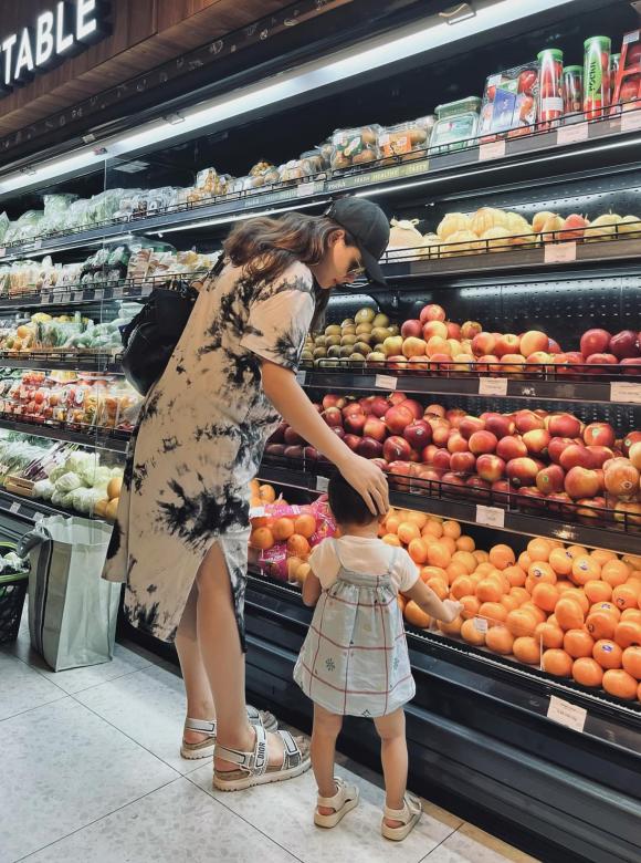 Con gái 1 tuổi chăm chú lựa trái cây giúp mẹ