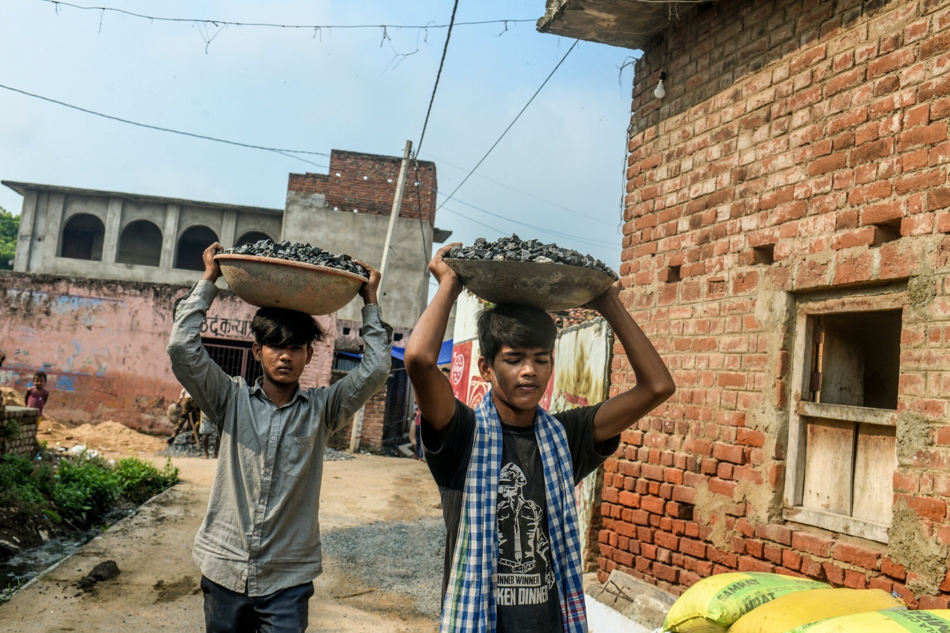 Mumtaz, bên trái, 12 tuổi và em trai Shahnawaz, 10 tuổi, đang làm việc tại một công trường xây dựng ở Gaya, Ấn Độ.