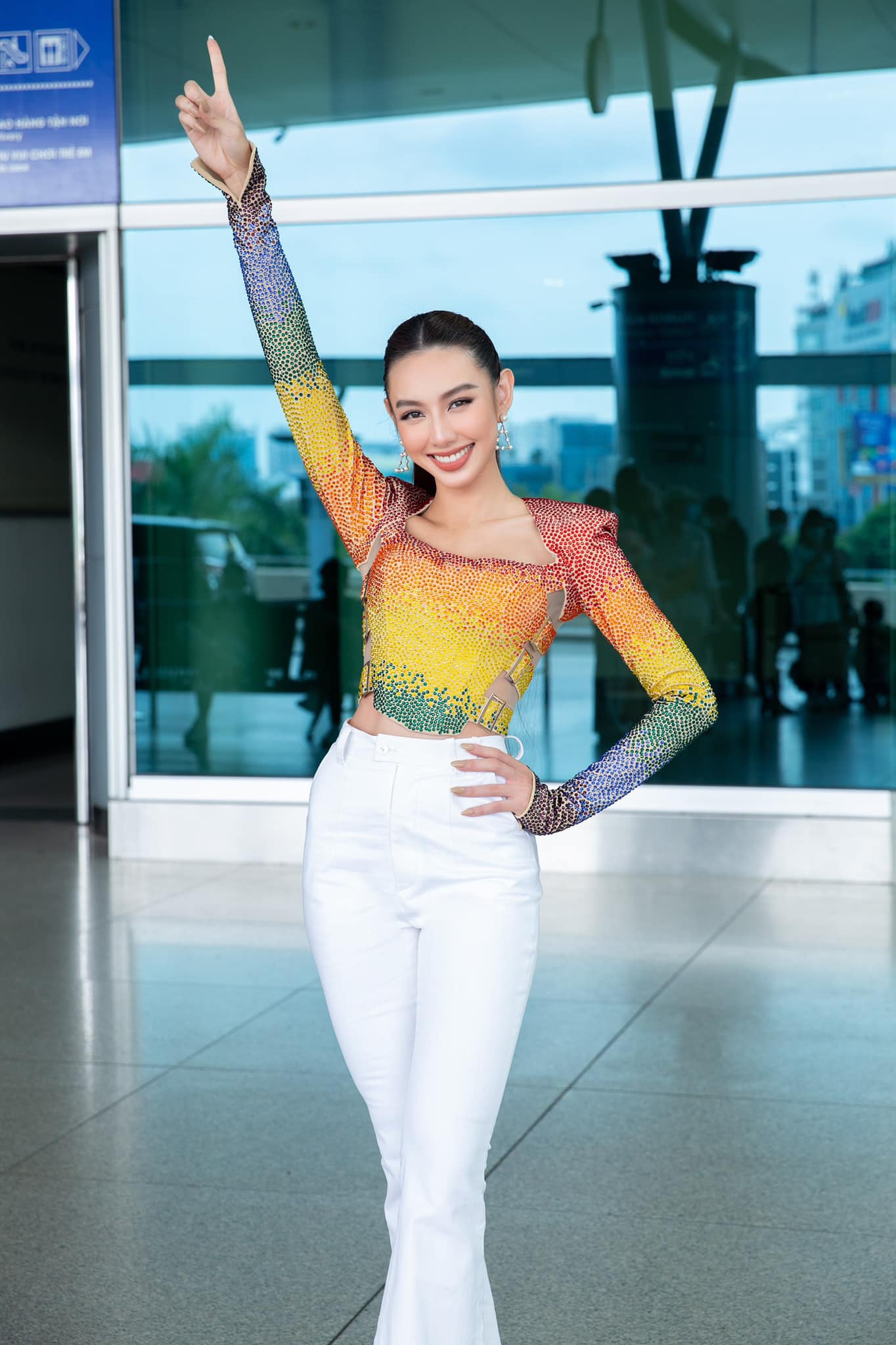 Trong ngày đầu tiên sang Thái, vì phải di chuyển máy bay và mang vác vali, Thuỳ Tiên chọn một outfit năng động trẻ trung với áo nhiều màu và quần suông màu trắng.