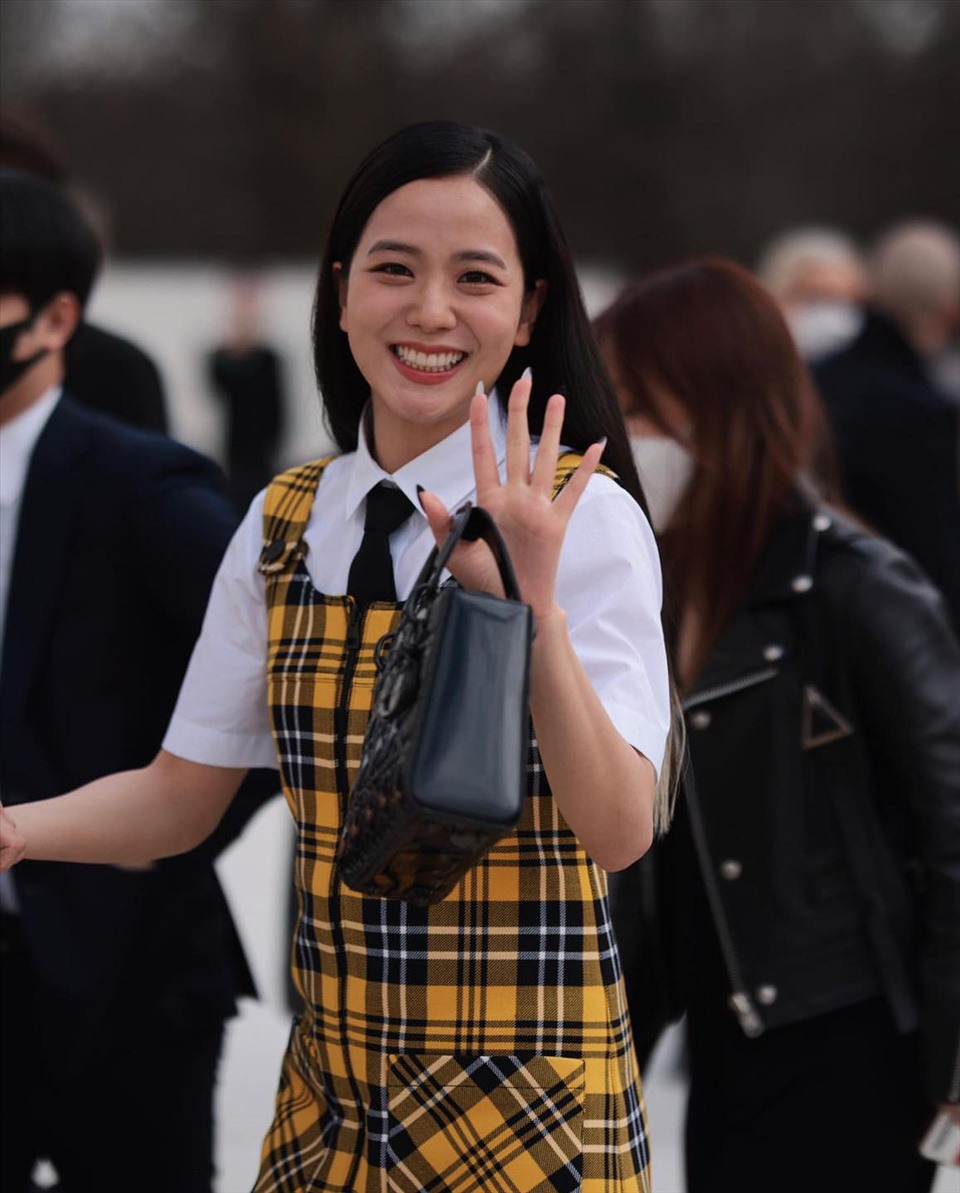 Nếu bạn chưa quên, lần xuất hiện gần nhất tại Paris Fashion Week, Jisoo mặc nguyên cây Dior với váy yếm hai dây kẻ caro màu vàng tươi và áo sơ mi trắng baby doll. Nữ idol cũng chọn cà vạt đen làm điểm nhấn cho vùng cổ áo đơn điệu.