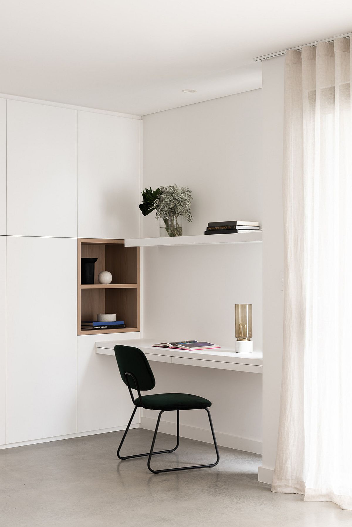 Phòng làm việc này đơn giản nhưng đẹp với bàn kệ gắn tường tiết kiệm không gian sàn.