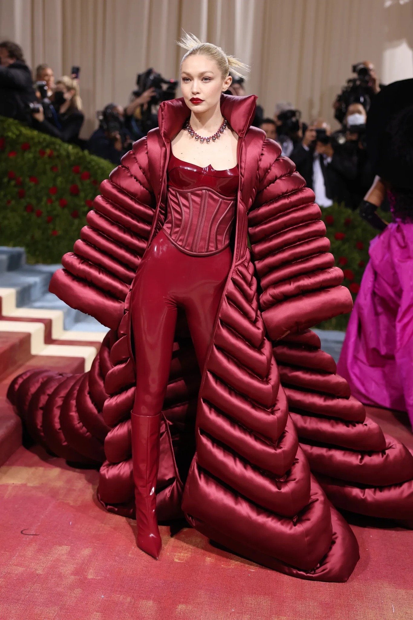 Gigi Hadid quyến rũ và 'bốc lửa' trong thiết kế bodysuit bằng da màu đỏ rượu cùng áo choàng phao lạ mắt.