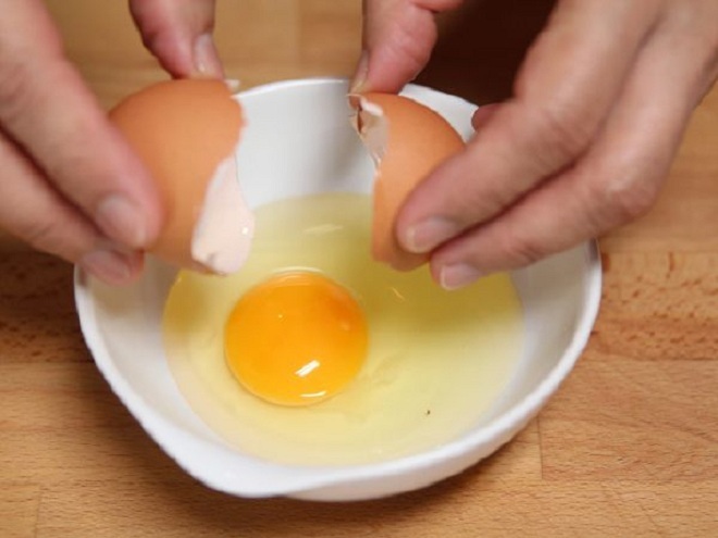 Đập 2 quả trứng gà vào bát và đánh tan.