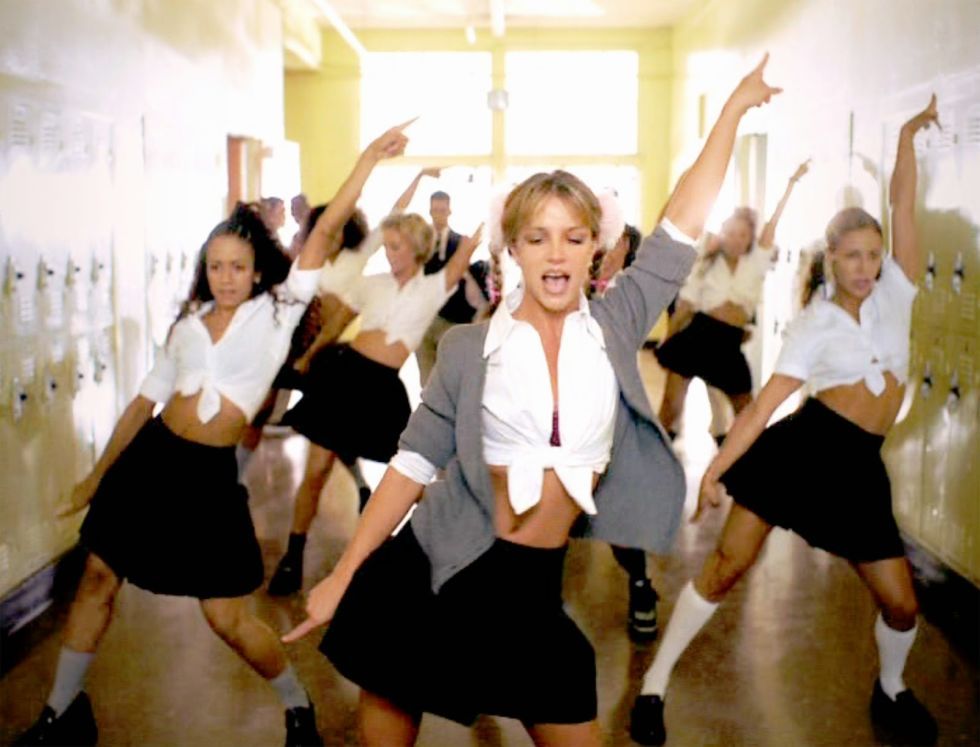 Trong MV Baby One More Time, nữ ca sĩ hóa thành cô học sinh cấp 3 đầy gợi cảm. Cô nàng diện một chiếc áo sơ mi trắng bung cúc lấp ló nội y, buộc cao khoe rốn. Cô mặc cùng áo cardigan, chân váy xếp ly.