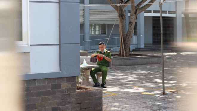 Trong khi túc trực tại điểm thi trường THPT Hắc Dịch, 1 chiến sĩ công an đã ngồi cặm cụi kết những chùm hoa phượng trong lúc các sĩ tử làm bài thi