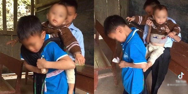Hình ảnh hai anh lớn địu em út vượt đèo đến trường khiến bao người rơi lệ