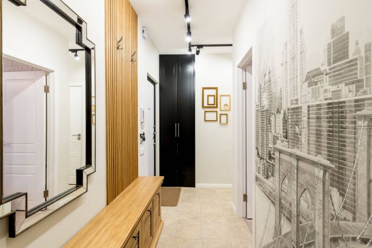 Lối vào được thiết kế với hai gam màu trắng - đen đối lập, cánh cửa ra vào sơn đen tạo chiều sâu và sự cuốn hút cho căn hộ.