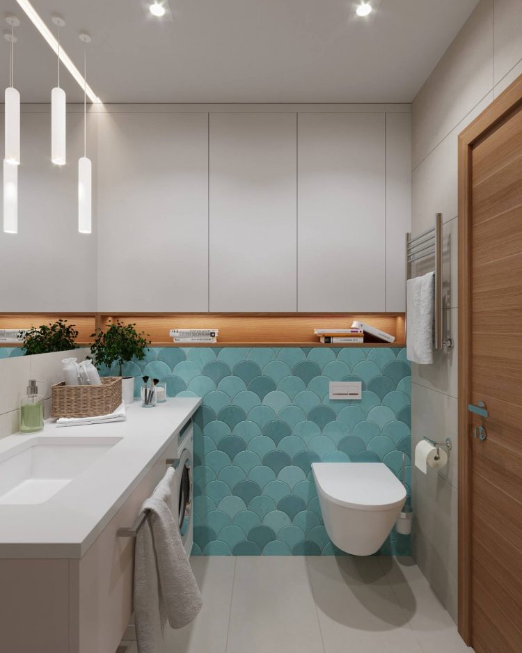 Bồn toilet được bố trí gắn tường để giải phóng diện tích mặt sàn, cho cảm giác phòng tắm rộng rãi và thoáng đãng hơn. Vì không có cửa sổ nên hệ đèn thả trần được tận dụng để tạo ánh sáng ấm áp cho không gian thư giãn.