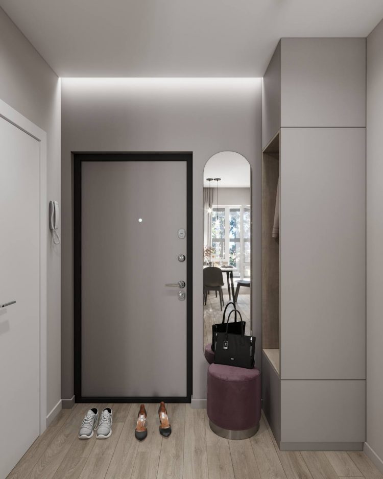 Lối vào căn hộ được bày trí đơn giản với chiếc tủ lưu trữ quần áo tiện ích. Tấm gương soi với hình chữ nhật đứng với các góc bo tròn đẹp mắt giúp nữ chủ nhân “làm điệu” trước khi ra khỏi nhà.