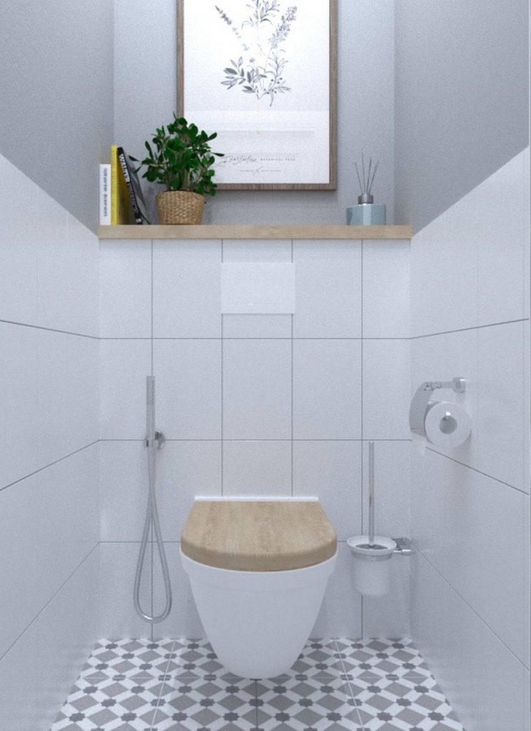 Bồn toilet gắn tường nhằm giải phóng mặt sàn cho không gian rộng rãi hơn. Phần nắp bồn, kệ mở bên trên và khung tranh đều bằng gỗ tạo cảm giác thân thiện, gần gũi với tự nhiên theo đúng tinh thần thiết kế mà chủ nhân mong muốn.