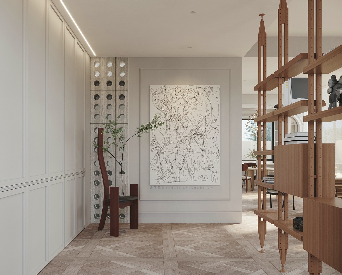 Một góc hành lang với nội thất đẹp mắt là chiếc kệ sách thiết kế mở như một vách ngăn tự nhiên giữa lối vào và khu vực sinh hoạt chính. Bức tranh trừu tượng cũng được sử dụng để trang trí cho mảng tường bớt trống trải.