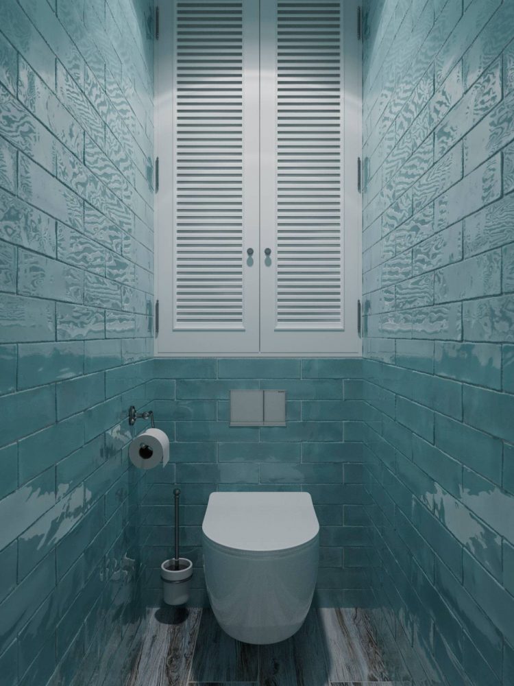 Nhà vệ sinh thiết kế cực kỳ đơn giản nhưng lại rất nổi bật nhờ gạch ốp tường màu xanh ngọc lam với bề mặt hoàn thiện sáng bóng khiến người sử dụng cảm giác như được ôm ấp giữa đại dương bao la.