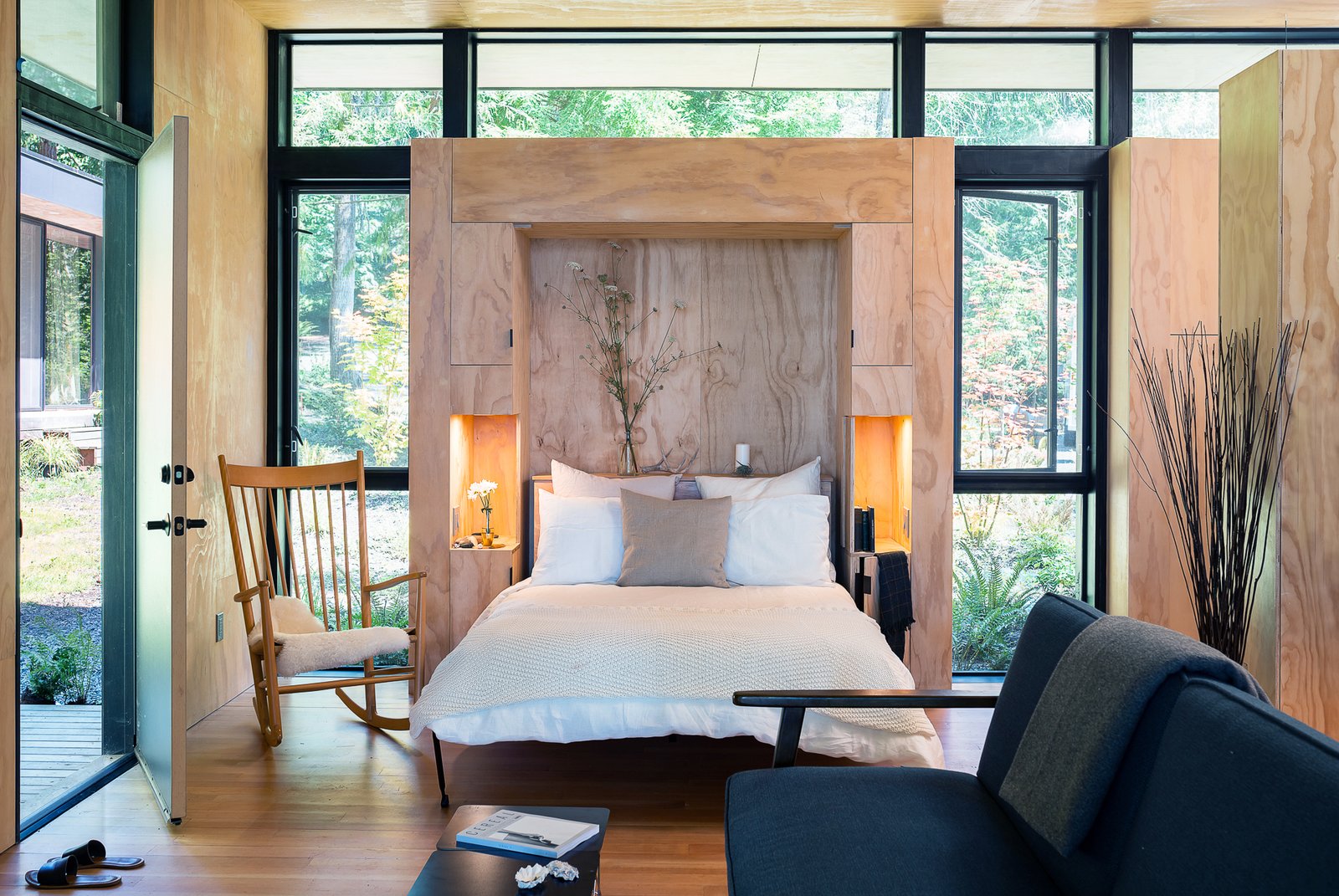 Ngôi nhà nhỏ lãng mạn bao bọc xung quanh bởi tường kính trong suốt nhìn ra cây cối xanh tươi. Giường Murphy vật liệu gỗ cũng đẹp mắt và hài hòa với khung cảnh.