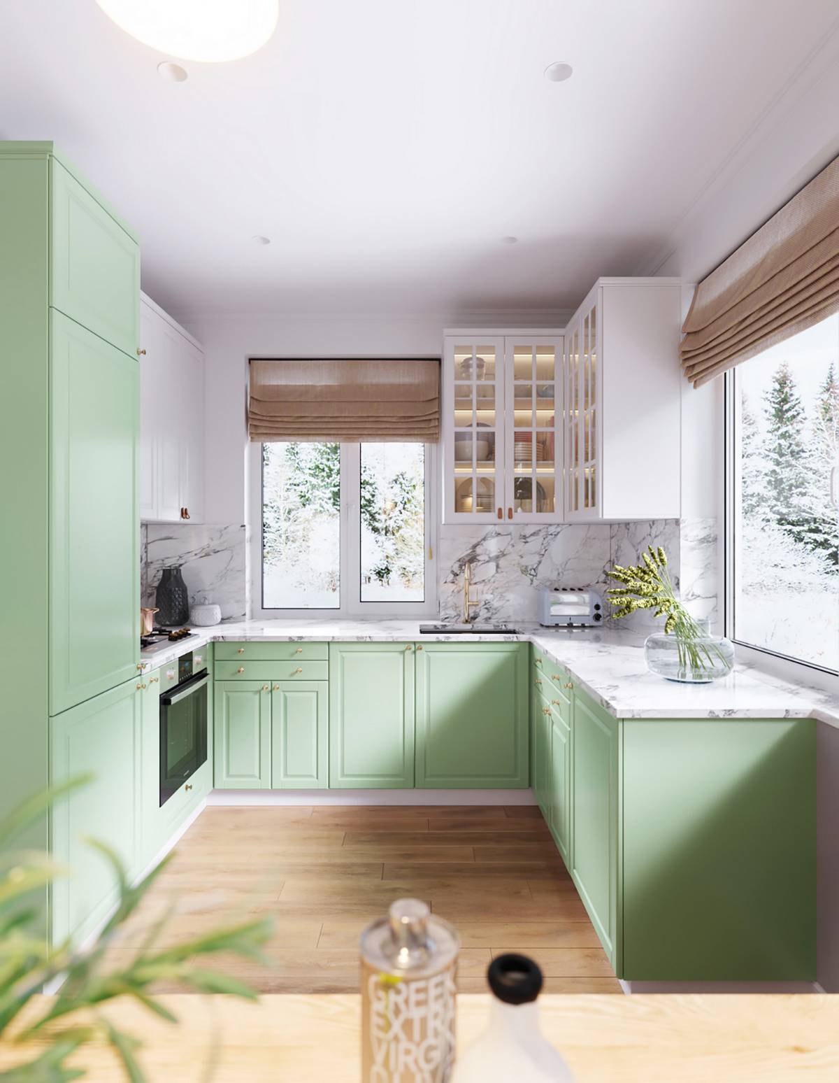 Hệ tủ bếp màu xanh bạc hà kết hợp mặt bàn ốp đá cẩm thạch sang trọng mang đến cái nhìn tươi mát, dễ chịu, xóa tan đi cảm giác nóng bức trong khu vực nấu nướng.