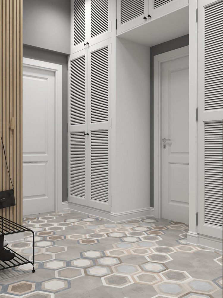 Lối vào căn hộ sử dụng gam màu trắng chủ đạo với tủ lưu trữ có kích thước rộng rãi từ trần đến sàn nhà. Gạch bông lát sàn họa tiết hình lục giác nhiều lớp màu ấn tượng.