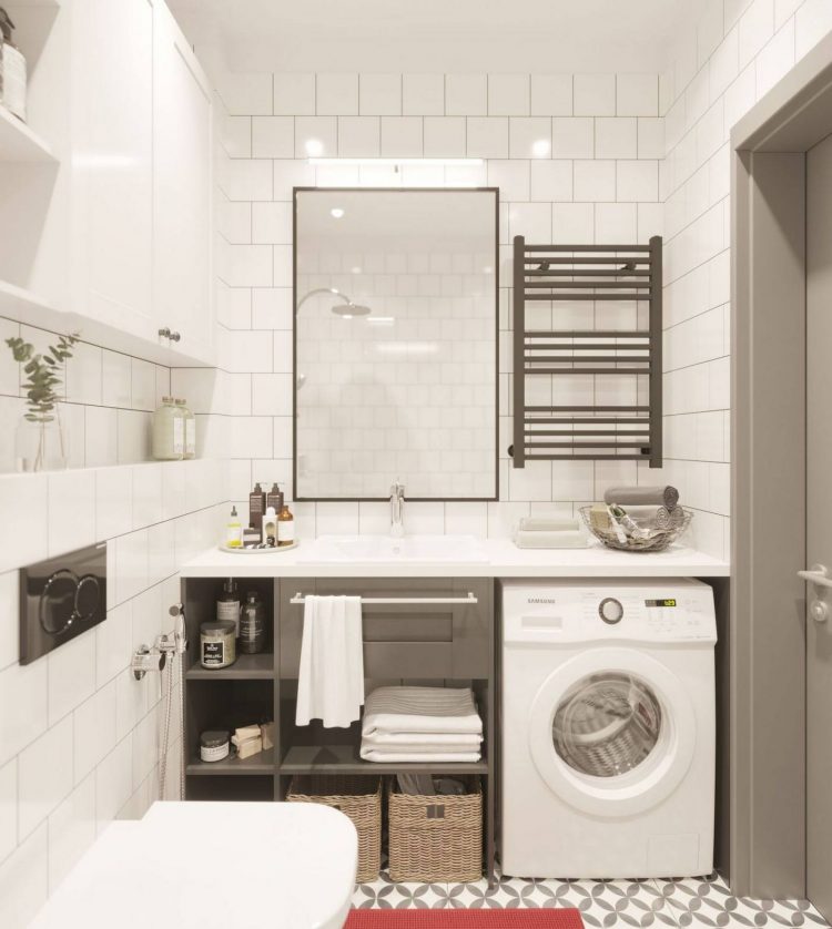 Tấm gương chữ nhật treo dọc bức tường như 'nhân đôi' phòng tắm. Kệ mở dưới bồn rửa và khu vực để bố trí máy giặt tạo nên sự tiện lợi và tiết kiệm không gian nhỏ.