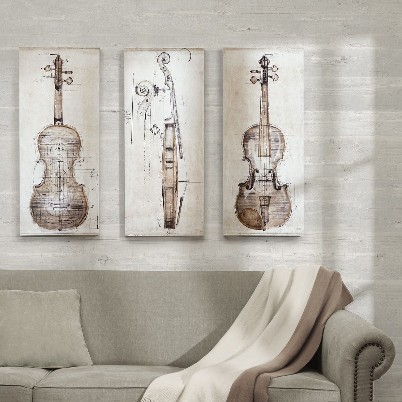 Bộ ba bức tranh phác họa đàn vĩ cầm trên nền vải canvas khiến bức tường sau chiếc ghế sofa phòng khách trở nên đẹp mắt và đỡ trống trải hơn rất nhiều.