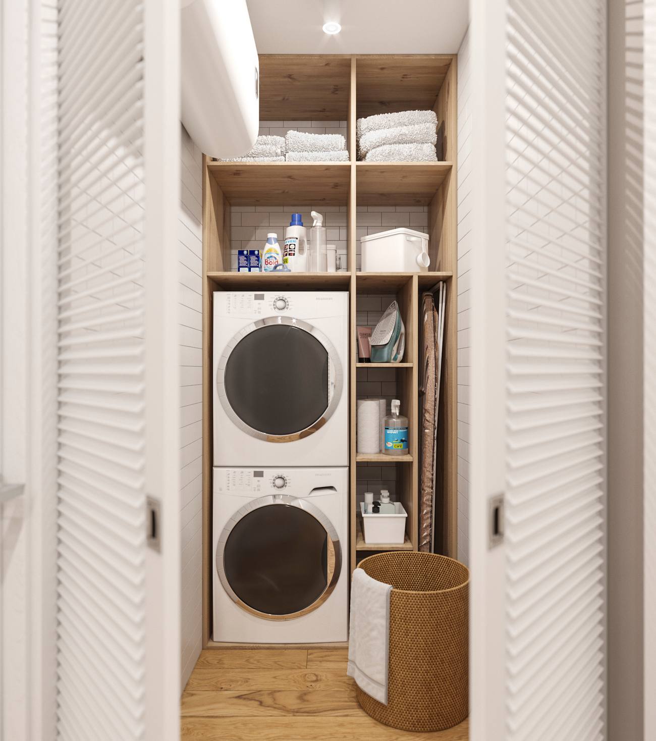 Phòng giặt là bố trí sau cánh cửa trắng, bao gồm kệ mở bằng gỗ nhiều ngăn. Máy giặt và máy sấy được xếp chồng lên nhau, tấm ván để là quần áo được gấp gọn, cùng một số vật dụng khác được sắp đặt khoa học, dễ dàng tìm kiếm khi cần sử dụng.