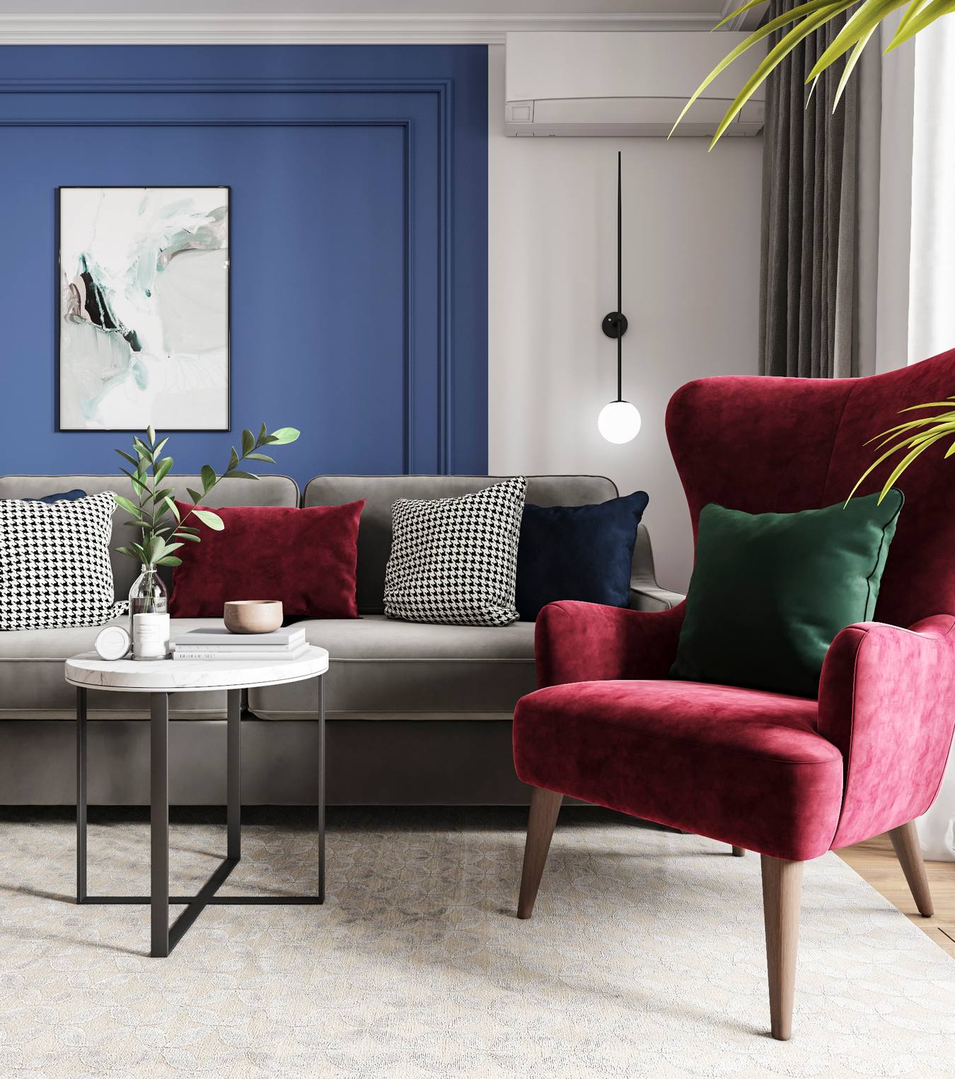 Phòng khách sống động với bức tường sơn màu xanh lam đậm và trắng. Bộ ghế sofa màu xám êm ái làm nền cho những chiếc gối bọc nhung màu đỏ, xanh lá, họa tiết kẻ trắng - đen bắt mắt.