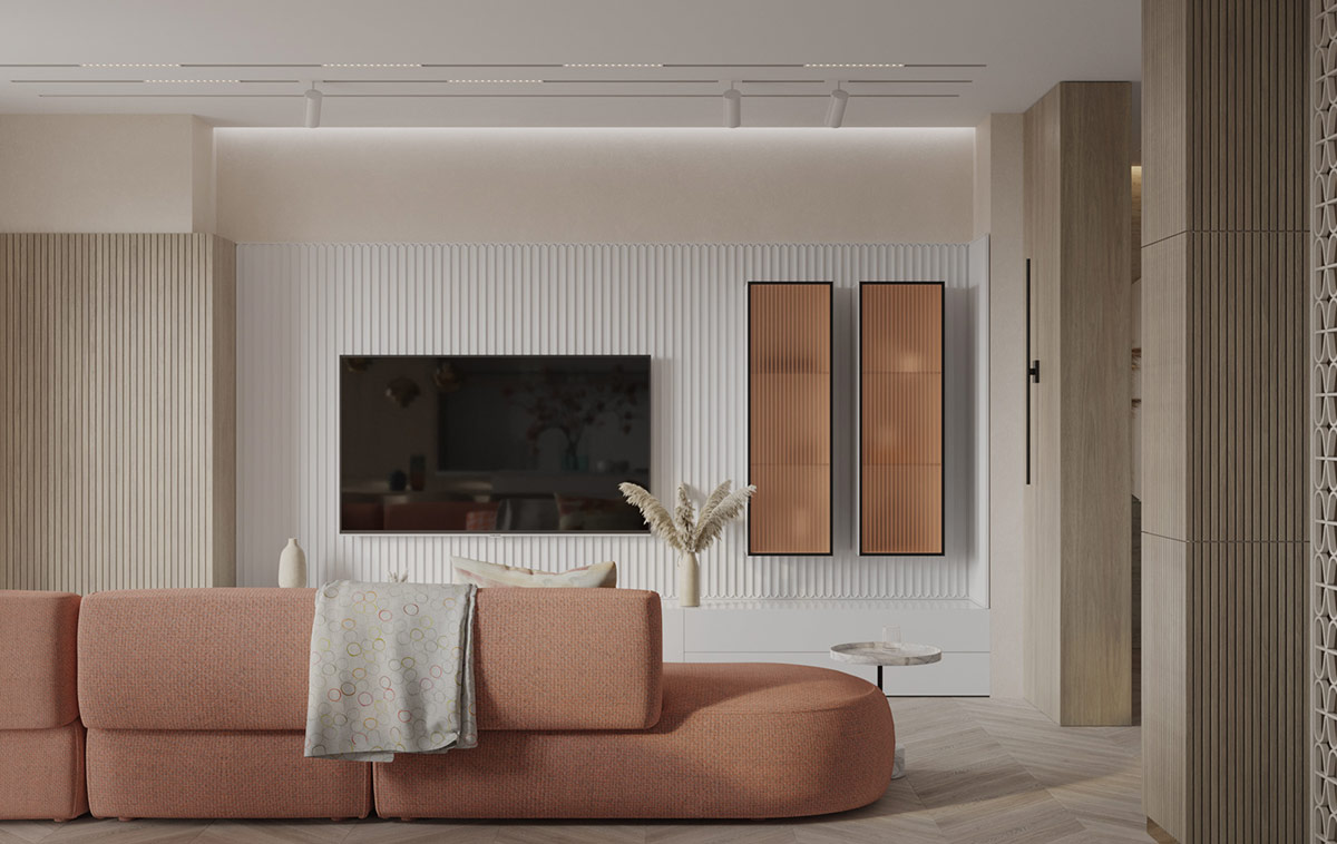 Tấm ốp gỗ và thạch cao có gân tạo họa tiết cho bức tường đối diện sofa. Hai chiếc tủ lưu trữ hình chữ nhật đặt dọc bức tường với cánh cửa màu hồng tạo sự liên kết với nội thất phòng khách.