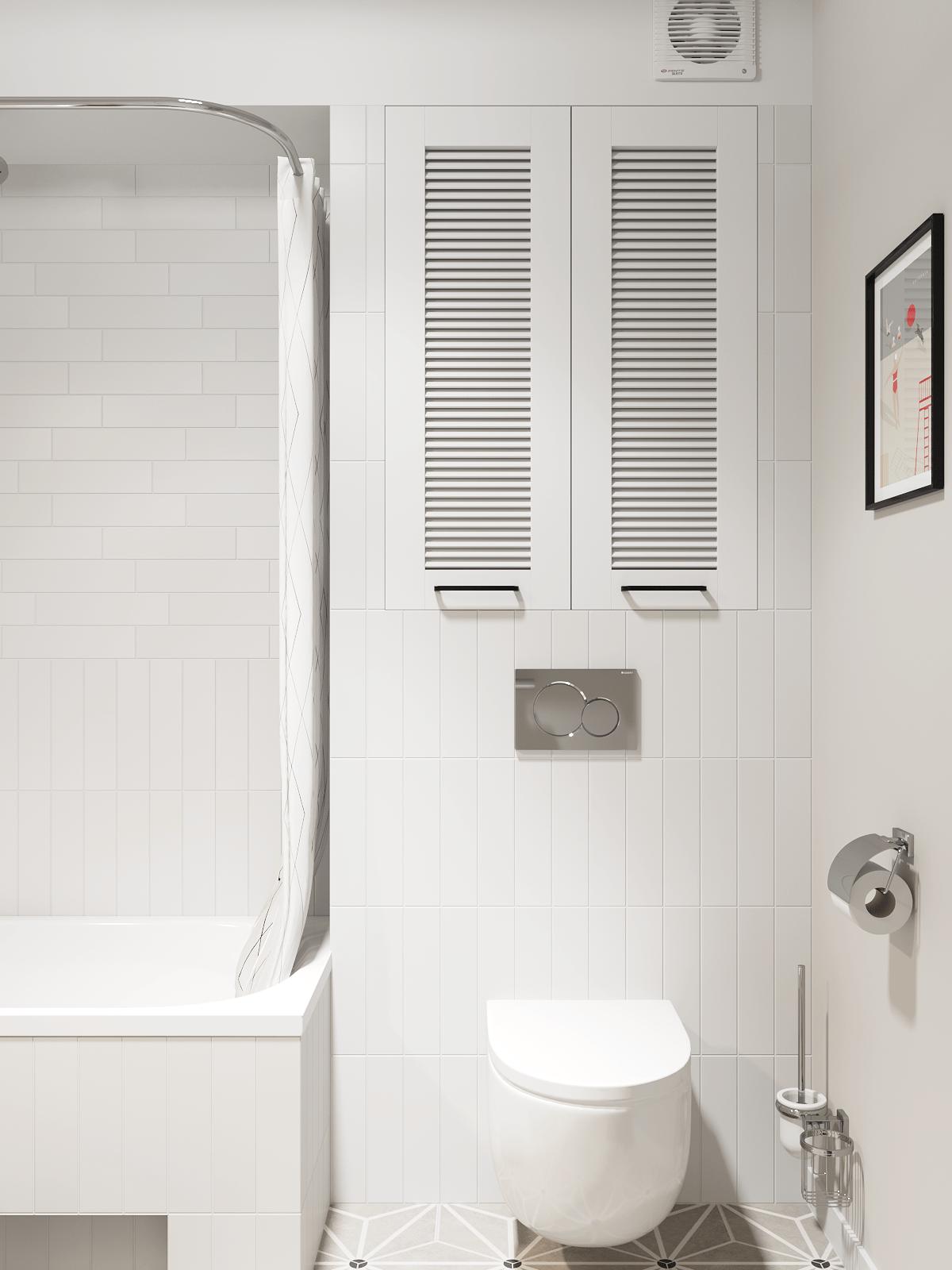 Sàn phòng tắm lát gạch bông tương tự phòng bếp để dễ dàng vệ sinh. Bên trên bồn toilet là tủ lưu trữ với sắc trắng đồng màu tường nên không gây cảm giác chật chội.