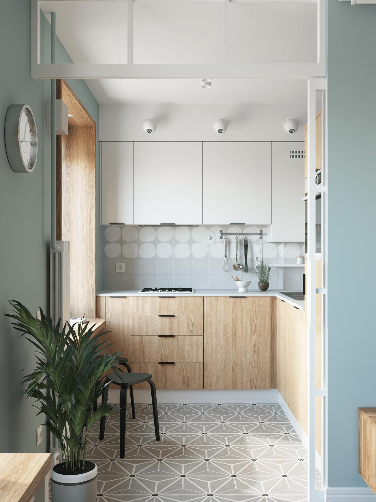 Phòng bếp được bố trí riêng biệt với thiết kế kiểu chữ L phù hợp với cấu trúc của căn hộ, đồng thời dùng gạch bông lát sàn để phân vùng với phòng khách lát sàn gỗ.