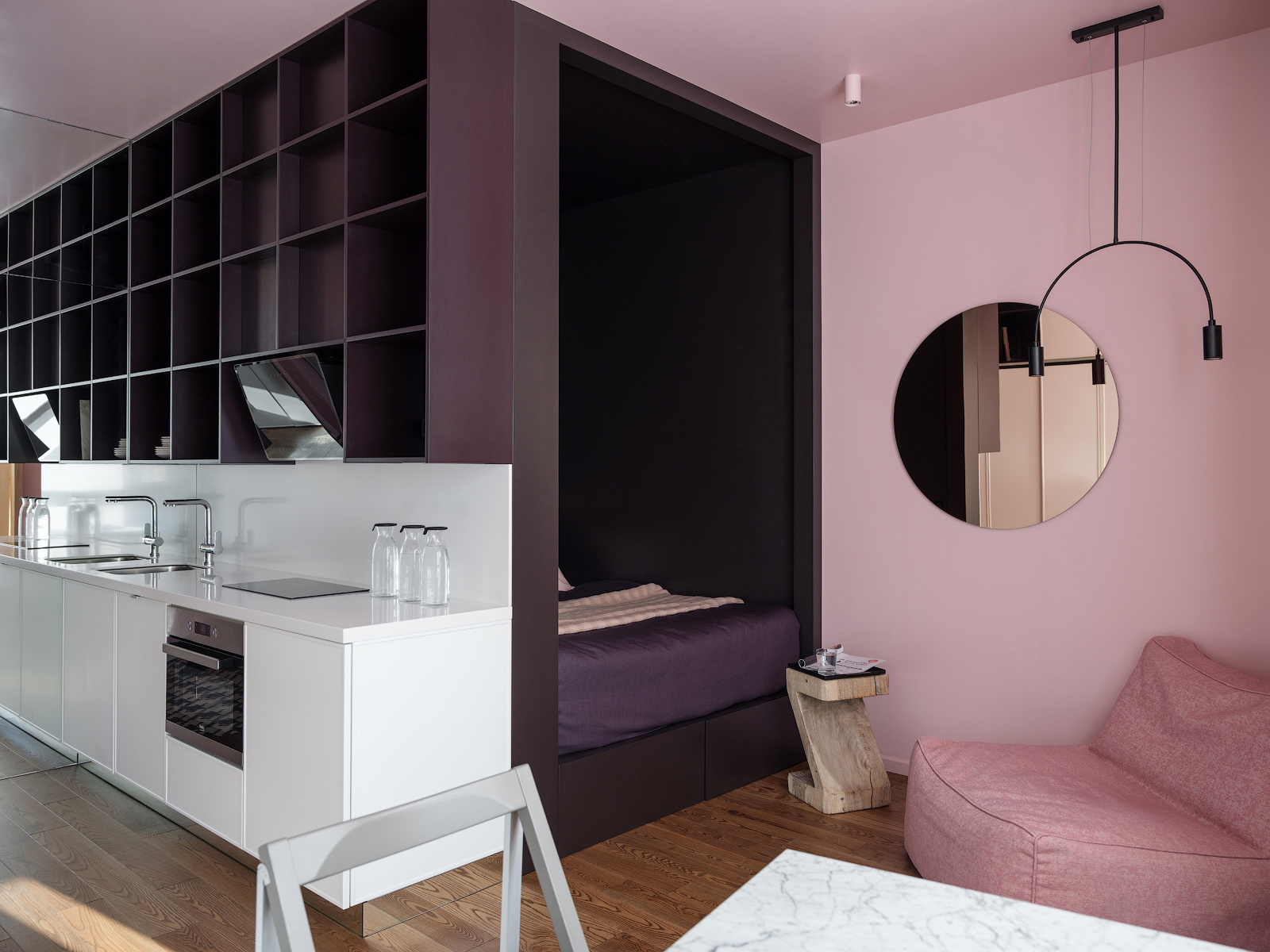 Thiết kế tuyệt đẹp bởi khả năng tối ưu hóa hốc tường sau phòng bếp cùng cách lựa chọn màu sắc. Hệ thống lưu trữ màu tím kết nối với đồng bộ phòng ngủ, sang đến bức tường bên cạnh chuyển màu hồng phấn cho cái nhìn vừa sang trọng vừa nữ tính.