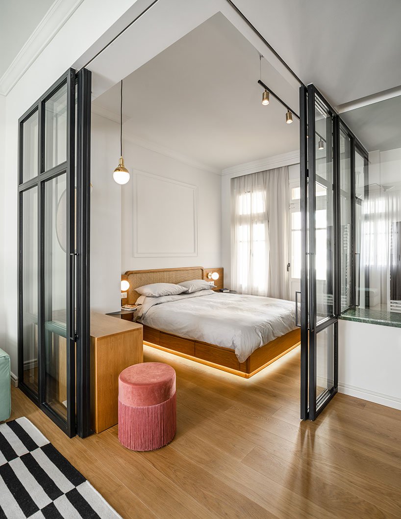Urban Soul Project đã khéo léo phân vùng phòng ngủ bằng hệ cửa kính trượt trong suốt. Đặc biệt hơn cả là chiếc giường bằng gỗ thiết kế thấp sàn, tích hợp cả đèn chiếu sáng xung quanh cho phần khung vô cùng ấn tượng.