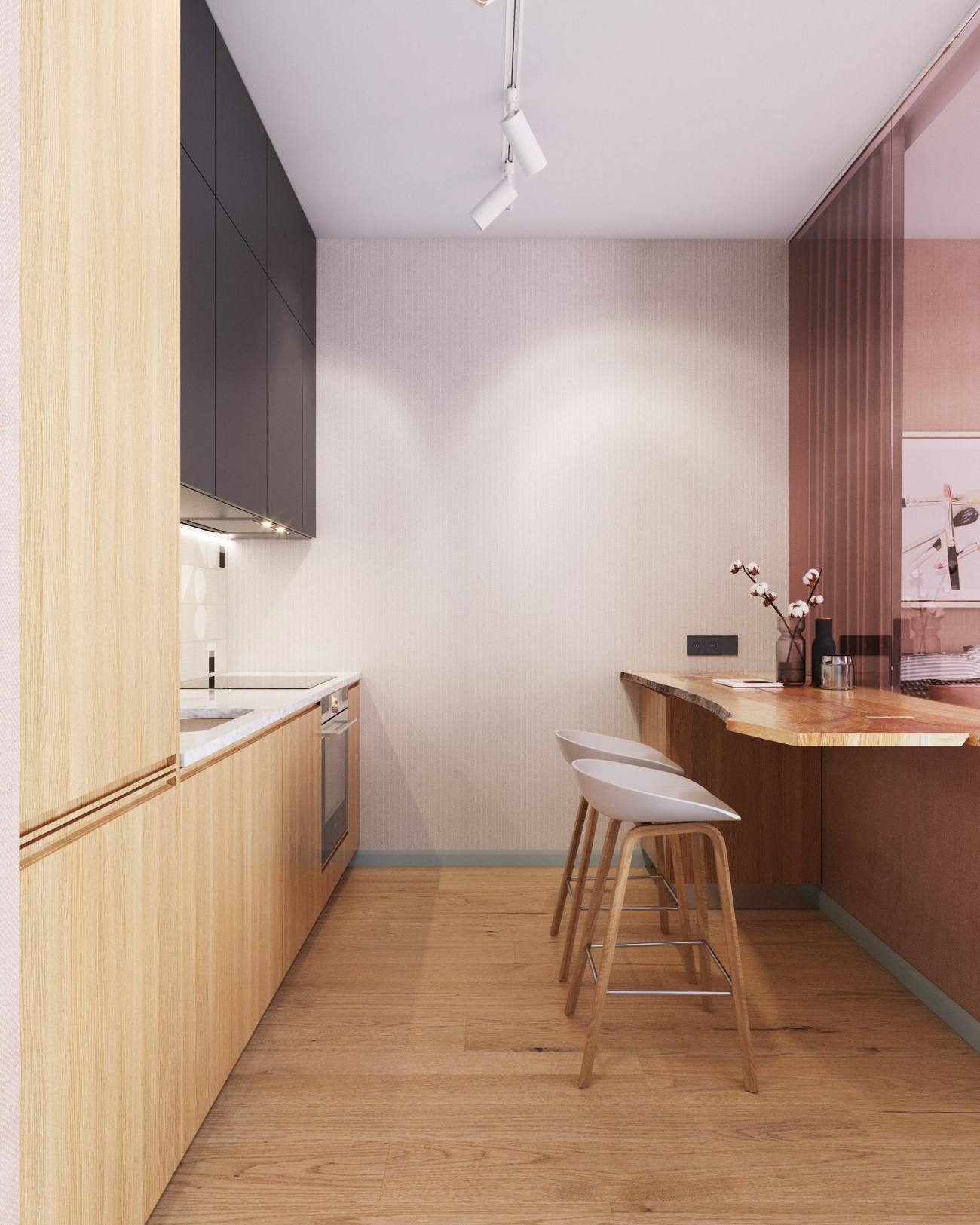 Đối diện bếp là quầy bar ăn sáng thiết kế gắn tường, phân vùng với phòng khách - phòng ngủ bằng cửa kính tone màu hồng phấn điệu đà. Lựa chọn này giúp cho khu vực nấu nướng đón nhận được nguồn sáng tự nhiên duy nhất từ ô cửa chính, bên cạnh hệ thống đèn trần phía trên.